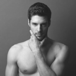 A male model poses for a photo.