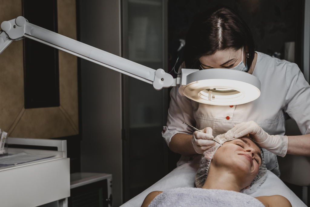 A woman is happy while undergoing dermaplaning because the cost is affordable.
