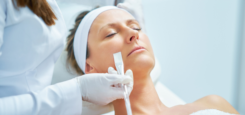 A woman is undergoing dermaplaning and plans to undergo six to twelve treatments for optimal results.