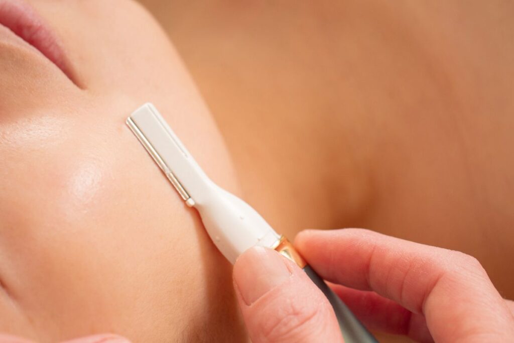 A woman is having a dermaplaning at home.