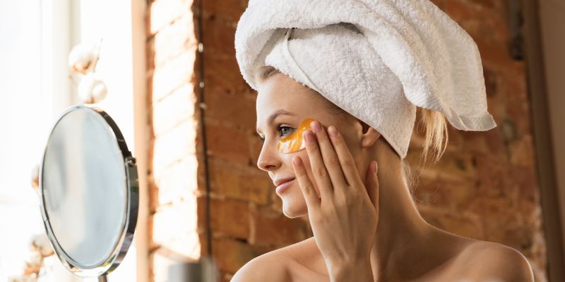 A woman is happy while having a dermaplaning at home on her own.