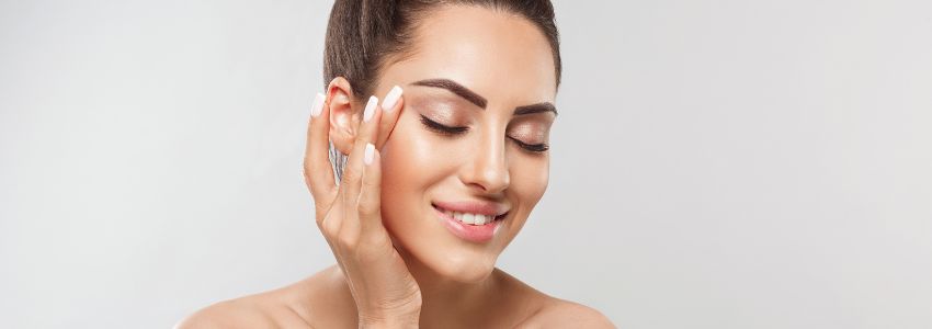 The woman is happy to the result of her exfoliating facial treatment.