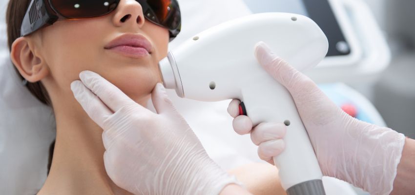 The woman undergoes laser hair removal.